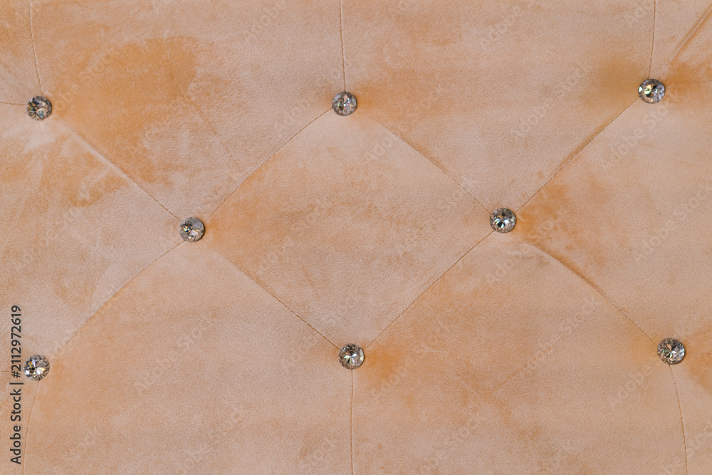 Obraz premium Beige Velvet Tufted Upholstery Texture with Diamond Rhinestone Buttons Pattern Background