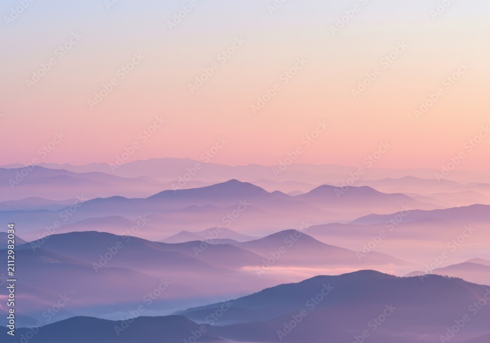 Obraz premium Soft pastel sunrise over layers of misty mountains, creating a serene and tranquil natural landscape