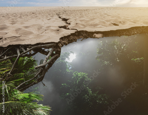 conceptual landscape of a cracked desert surface revealing a thriving tropical rainforest below