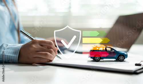 Insurance agent reviewing documents with car insurance protection icon, vehicle coverage, policy approval, risk management, automotive finance, claims process, and customer security.