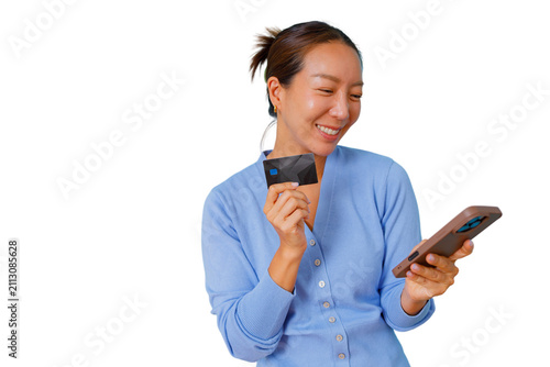 фотографія Asian woman smiling, holding a credit card and smartphone, accessing e-commerce