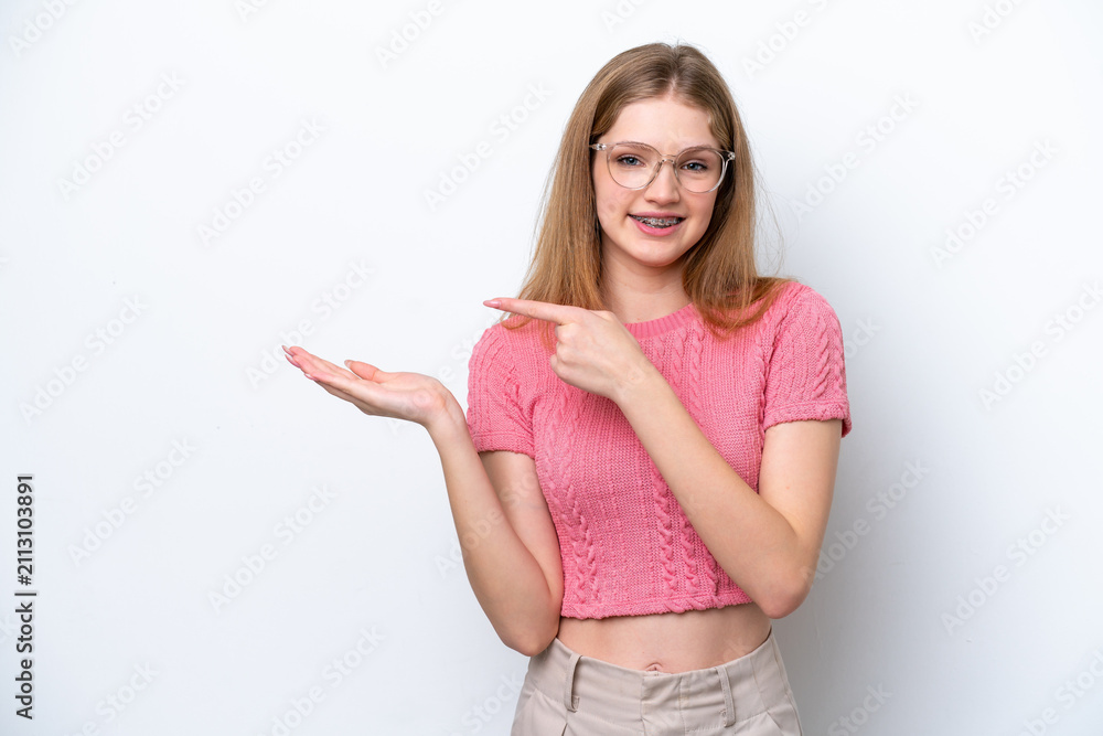 Obraz premium Teenager Russian girl isolated on white background holding copyspace imaginary on the palm to insert an ad