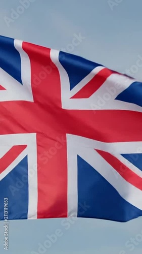 A vibrant national flag gently waving in the clear blue sky