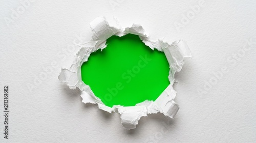 Принти на полотні Torn white paper hole with green background