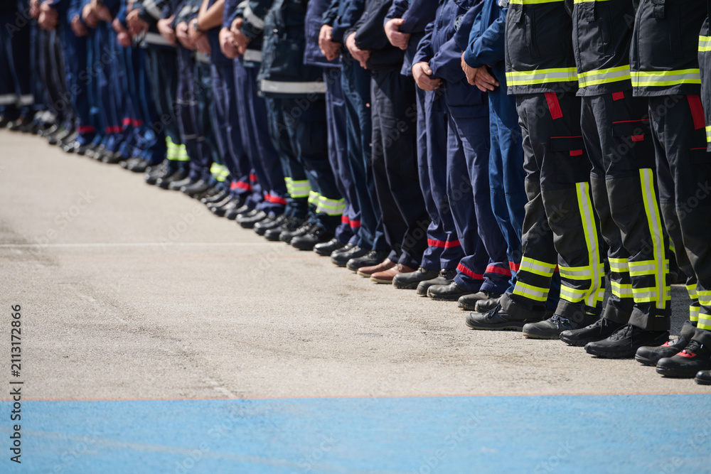 Obraz premium Line Of Firefighters And Emergency Crew Standing In Uniforms During Ceremony Or Drill