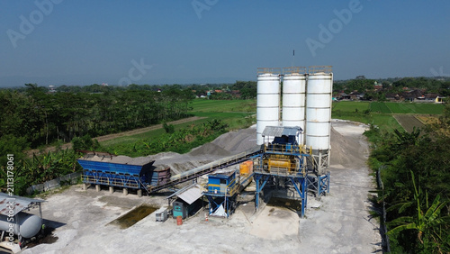 Aerial view of batching plant or concrete mixing plant facility, large cement mixer, and a truck