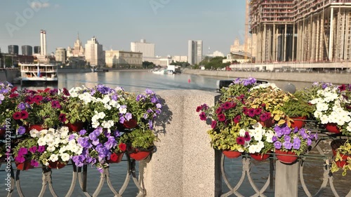 Moscow city skyline with river and White House from a flower-decorated bridge