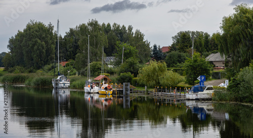 Sailboats and boats moored at a small marina on the Szkarpawa River.