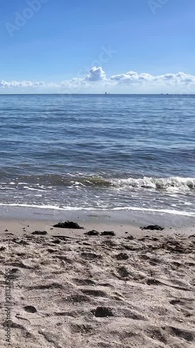 Calm sea waves washing over sandy beach