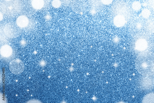 Blue New Year's glitter background with sparkling bokeh lights for holiday decoration and special events.