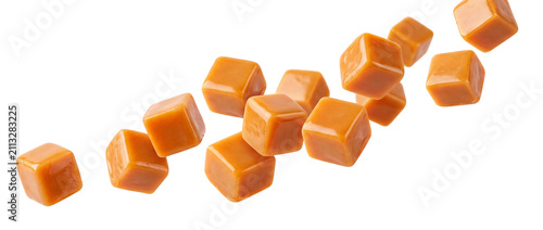 Quadro su tela Caramel cubes falling isolated on transparent background