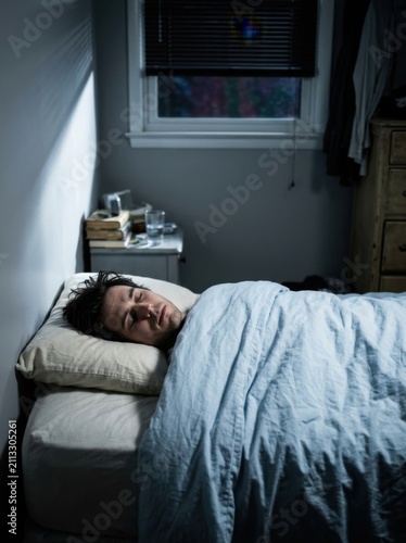 Man Sleeping Peacefully In Bed At Sunrise With Soft Light
