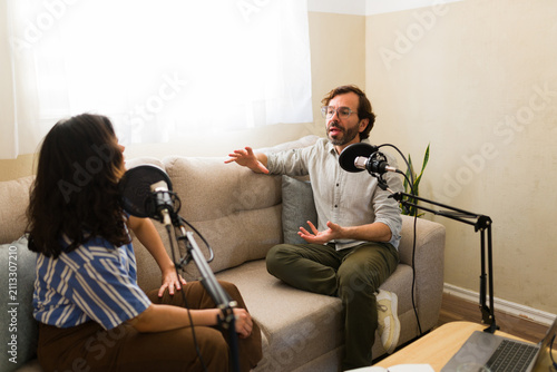 Cuadro en lienzo Two podcasters creating new content, talking and recording a podcast episode at