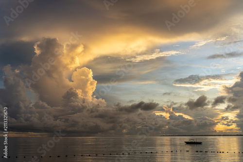 Dramatic sunset over the ocean with orange colour cumuls clouds