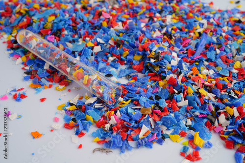 Fotografie Plastic colorful pieces recycling shredded for industrial use.