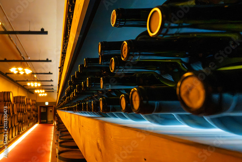 Close-up of Bottoms of Stored Wine Bottles with Blue Light Underneath
