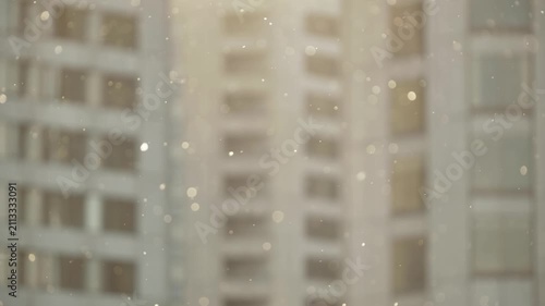 Warm sunlight illuminating tiny dust motes in front of an abstract urban backdrop