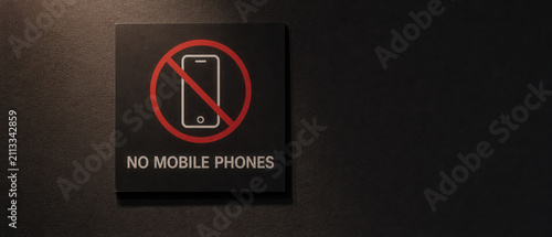 No Mobile Phone Sign Mounted on Dark Textured Wall