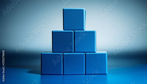 blue cubic blocks stacked in a pyramid on a smooth surface