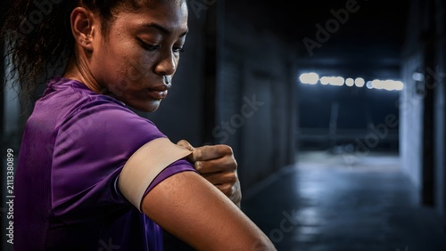 sports women's football 2026 women's africa cup of nations african female captain adjusting an armband in a stadium tunnel before a high pressure match

