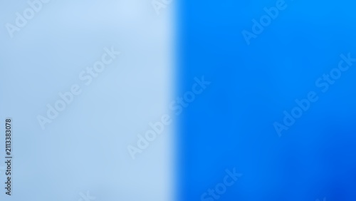 Фотография Minimalist vertical two-tone background with soft blurred gradient transition between pastel light blue and vibrant royal blue