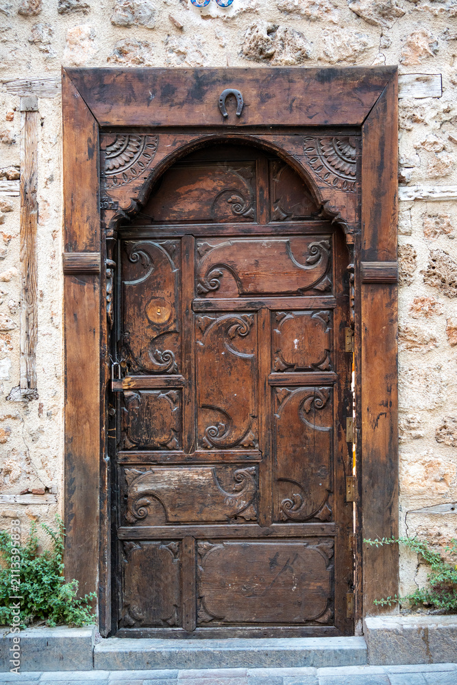 Fototapeta premium Ancient carved wooden door in Kaleici old town Antalya Turkey