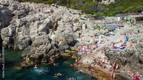 Quadro su tela Panoramic drone shot of Punta Carena lighthouse beach and swimming people in Cap
