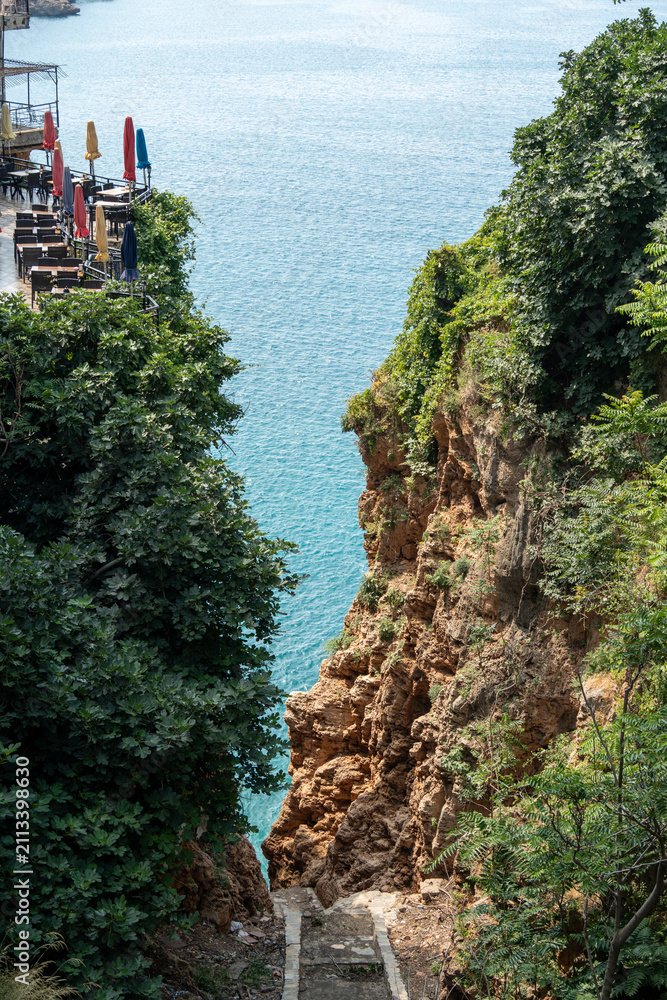 Fototapeta premium Scenic cliffside restaurant terrace overlooking Mediterranean sea in Antalya Turkey