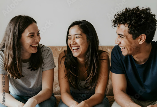 Three friends laughing toge...