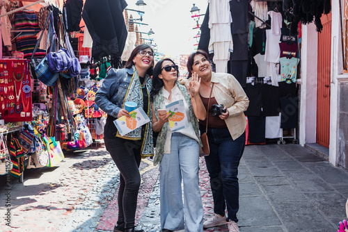 senior latinas friends women travellers in tourist market in Mexico Latin America, hispanic middle age females shopping in vacations 