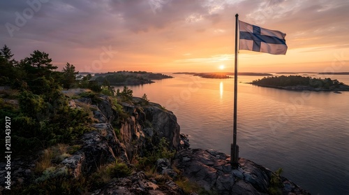 Finnish Flag Over Rocky Coast During Midnight Sun