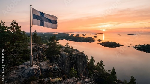 Finnish Flag Over Rocky Coast During Midnight Sun