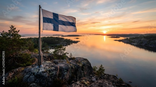 Finnish Flag Over Rocky Coast During Midnight Sun