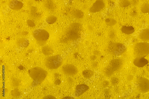 Bright yellow synthetic sponge texture in macro