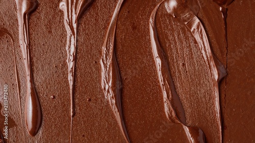 Close-up of melted chocolate with swirled and textured surface.