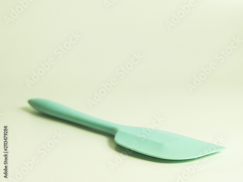 Light green silicone spatula cooking utensil isolated on clean white background