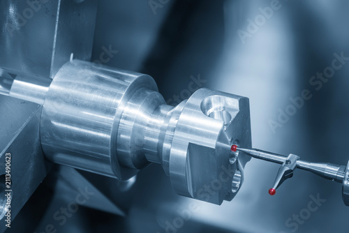 Quality control inspection on a CNC lathe machine using a modular probe in a blue tone scene.