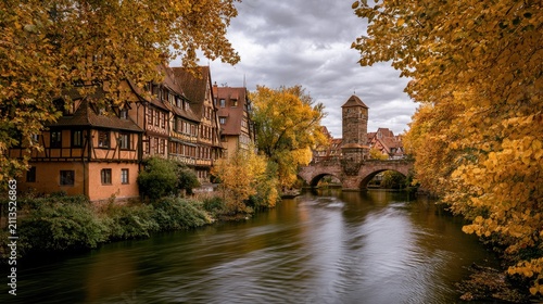 Autumn foliage frames a historic European canal with medieval architecture