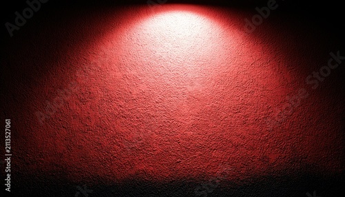 Textured red wall illuminated by a spotlight, creating a dramatic gradient effect