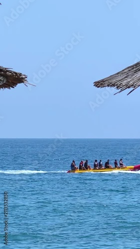Riding inflatable donut behind a fast boat, riding an inflatable ring on the sea