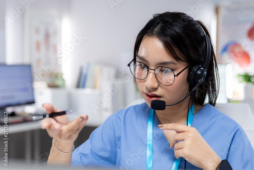Professional women wearing headset providing telehealth support in clinic, representing virtual consultation, patient communication, healthcare service, remote care, medical assistance.