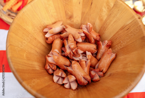 Canvas Print Close up of mini cocktail sausages served in a wooden bowl on a party buffet table