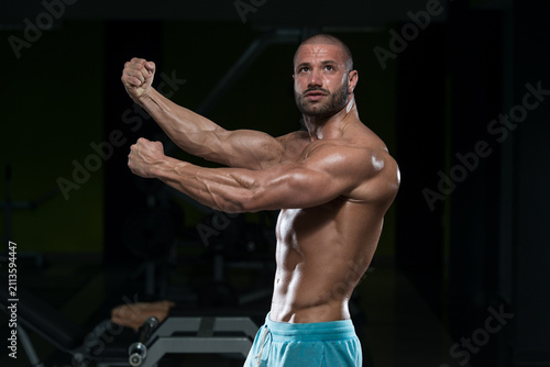 Young Man Flexing Muscles