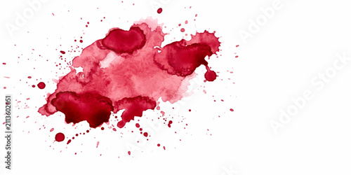 Foto A cluster of red blood droplets scattered across a white background, evoking a sense of urgency or medical concern