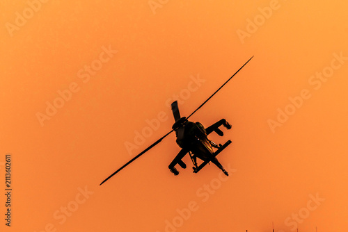 Close-up of helicopter is turning on isolated sky during dawn