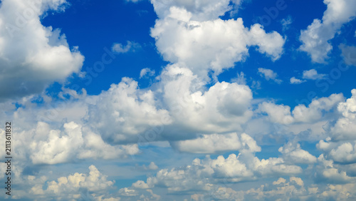 фотографія many cumulus clouds cover the entire blue summer sky