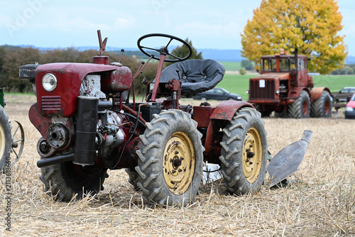 old articulated mini tractor with a plow