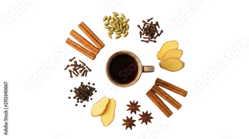 Cup of hot masala chai tea surrounded by aromatic spices like cinnamon sticks ginger cloves cardamom and star anise