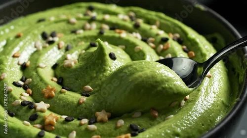 Creamy green mousse with sesame seeds and silver spoon