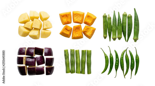 Fresh chopped vegetables including potatoes pumpkin okra eggplant and green beans arranged in small piles for cooking
